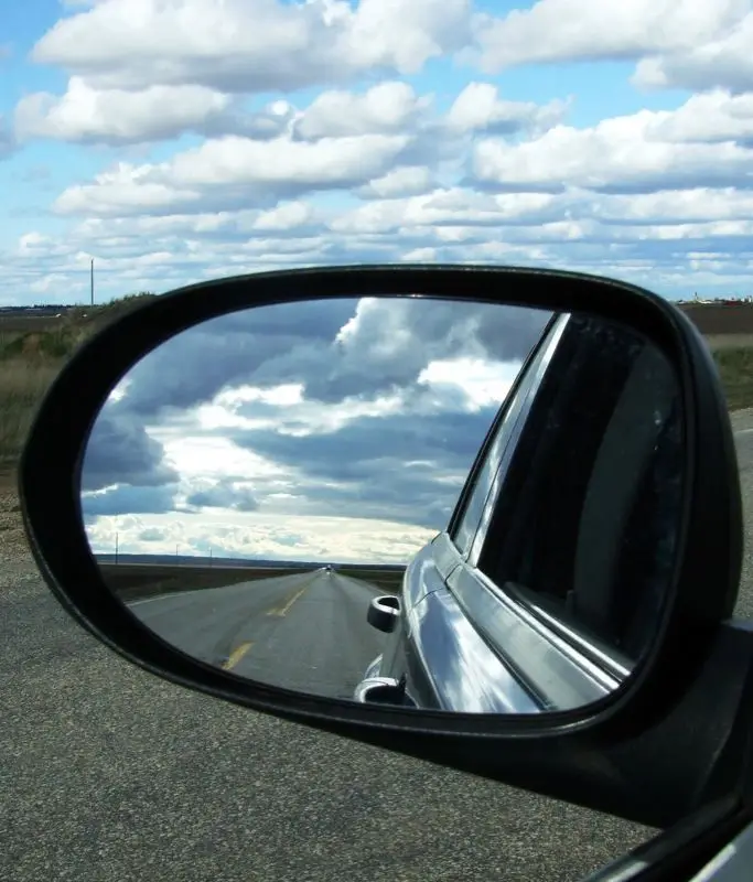 Prairie road and sky in a car mirror, 2010